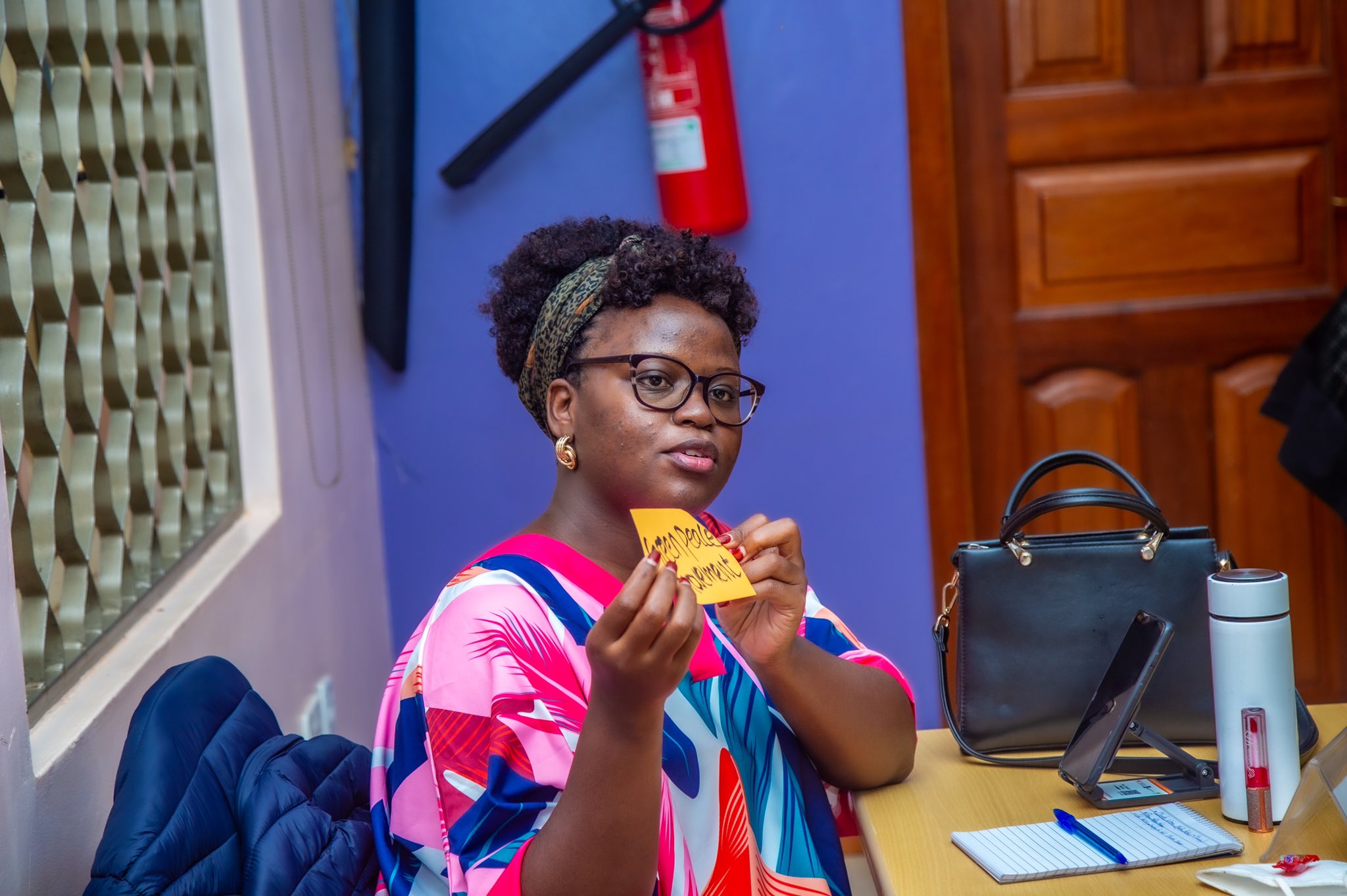 Esther Bridget Nakalya, one of the female journalists gestures and shares a response during the session