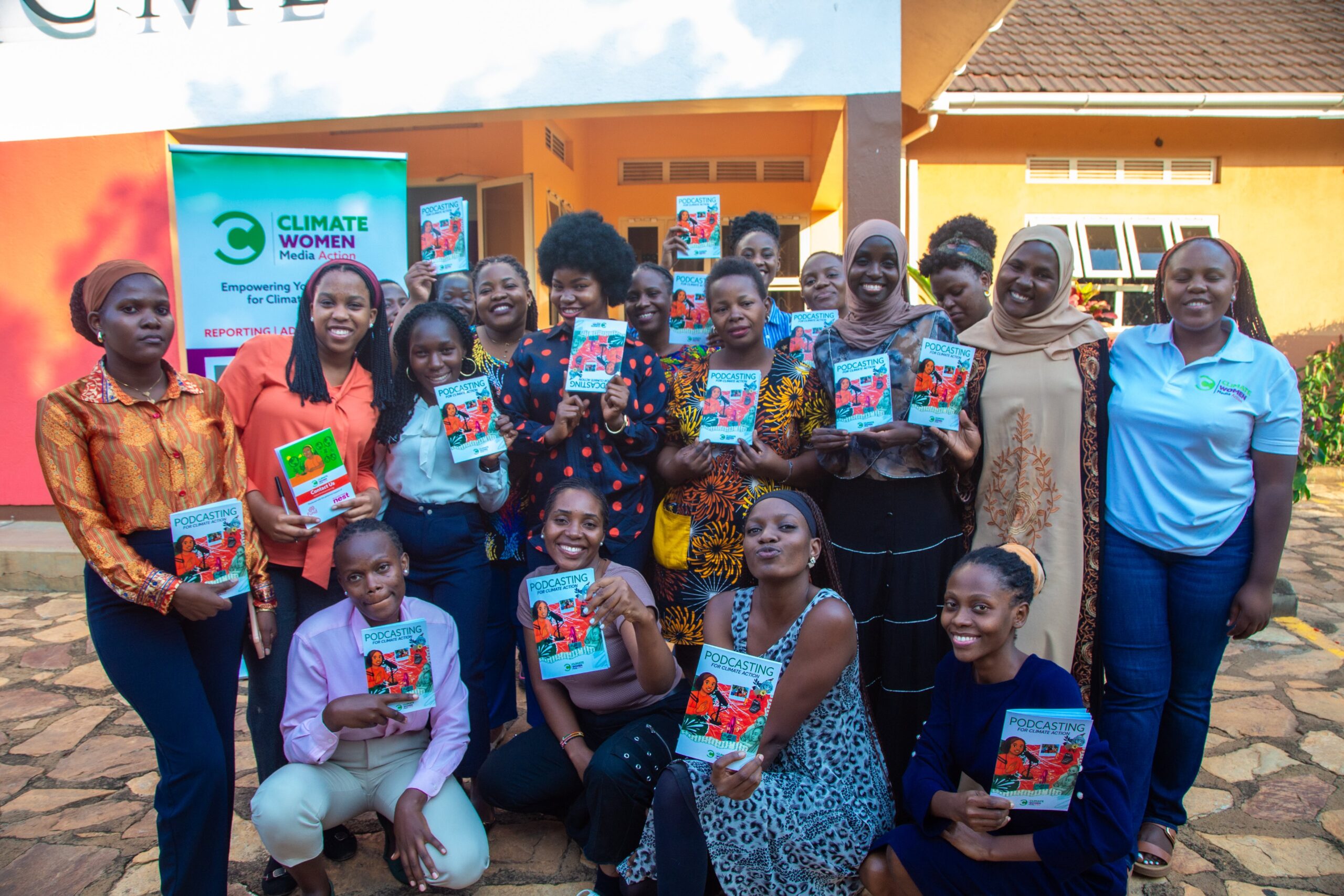 Journalists take a group photo with their podcasting handbook