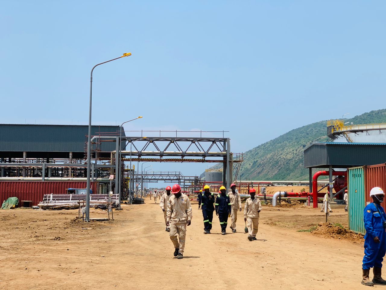 Casual laborers return from a lunch break at the King fisher Oil project.
